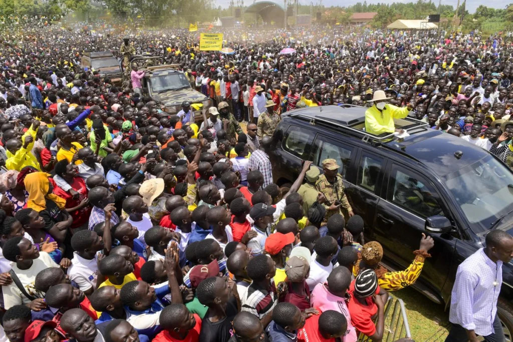 Fans cheer on Museveni as he arrives at the campaign rally